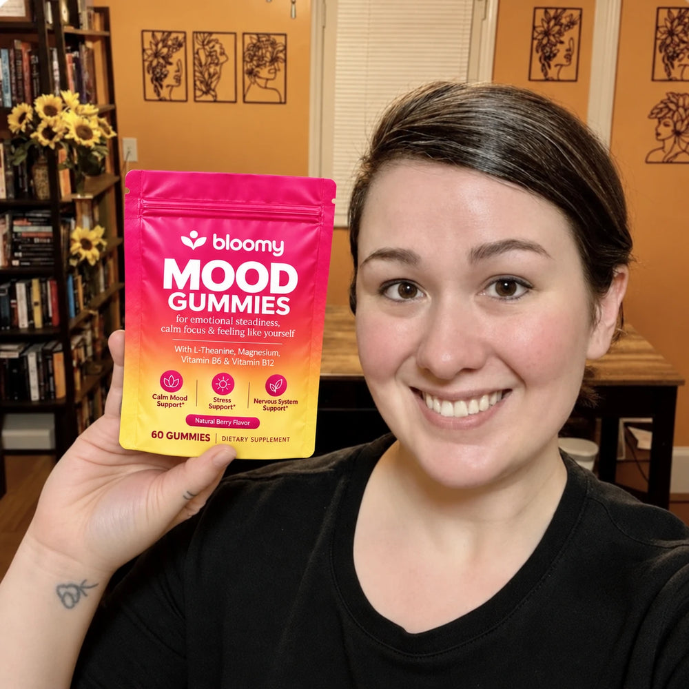 Lifestyle photo of a woman holding a Bloomy Mood Gummies pouch