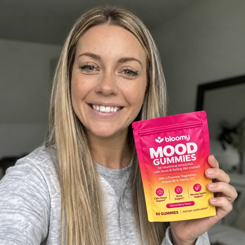 Lifestyle photo of a woman holding a Bloomy Mood Gummies pouch