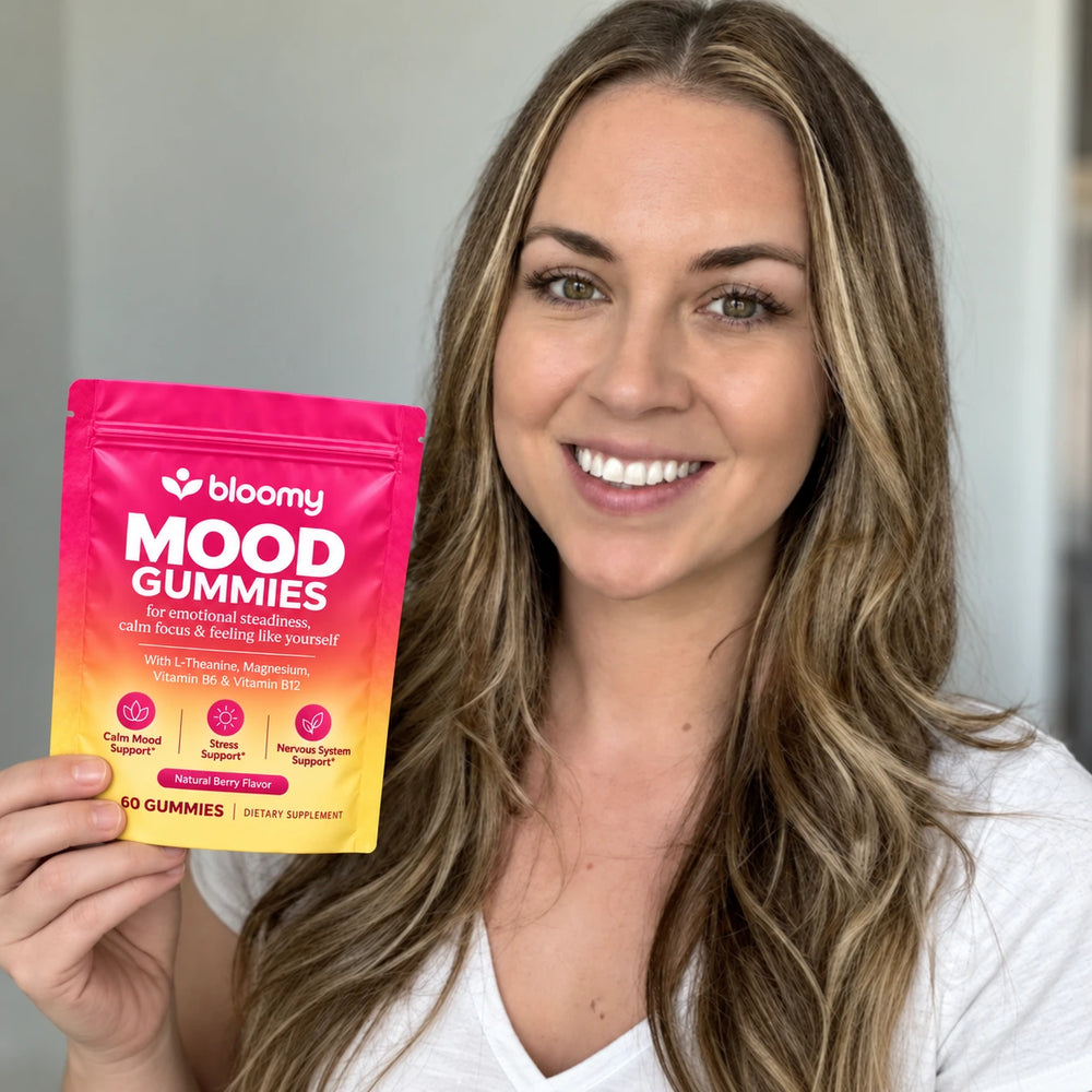 Lifestyle photo of a woman holding a Bloomy Mood Gummies pouch